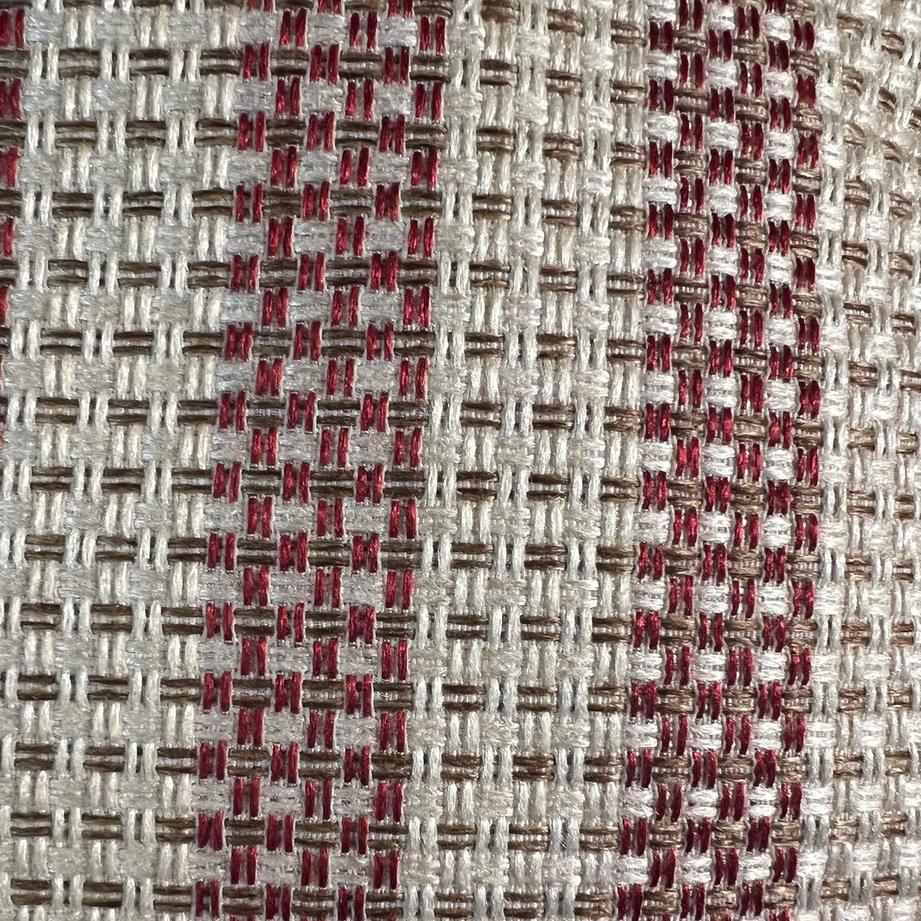 A close up to the brick red and ivory stripped cushion cover