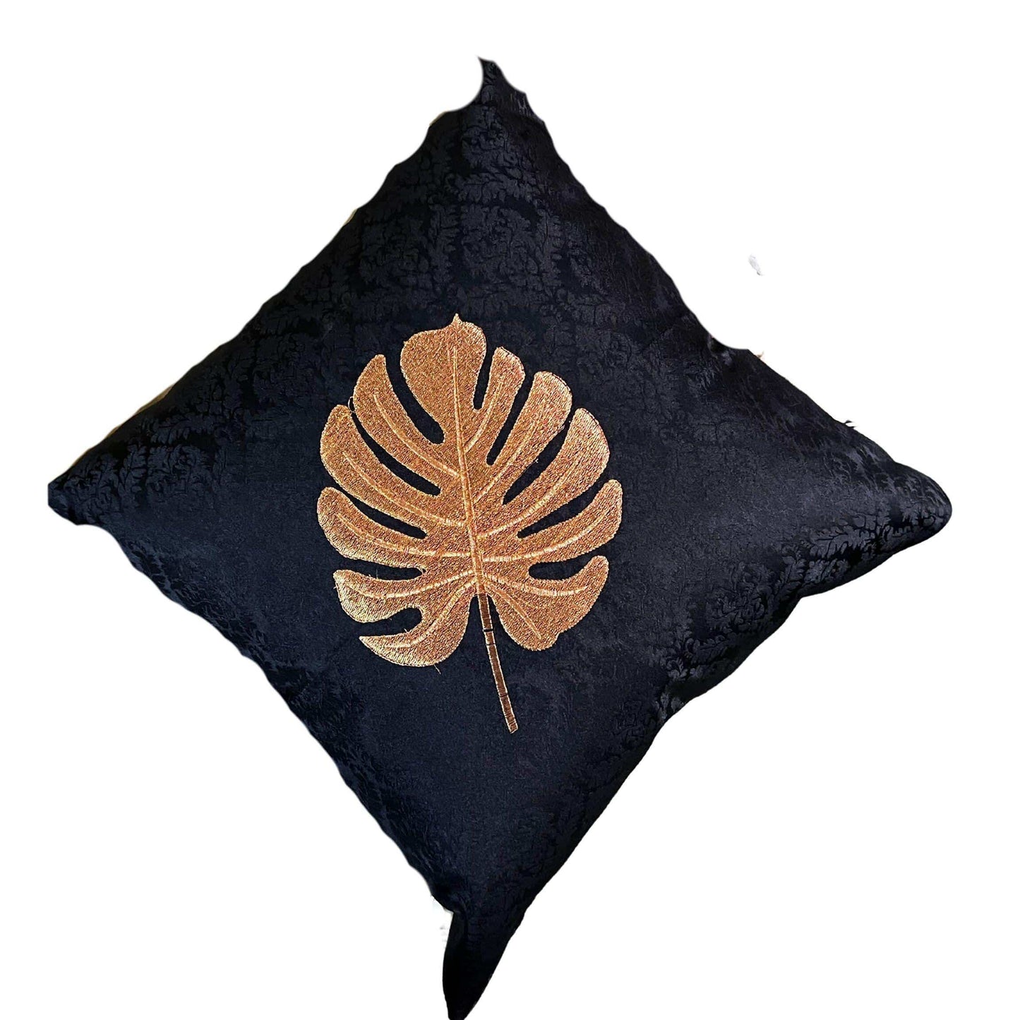 Black cushion with a golden leaf