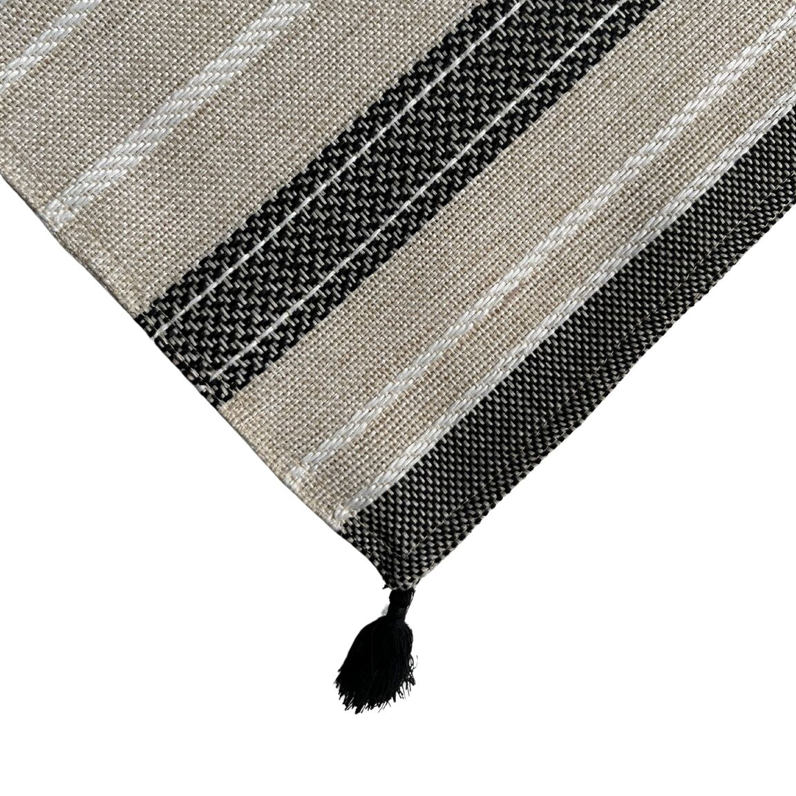 A placemat with bold stripes and tassle