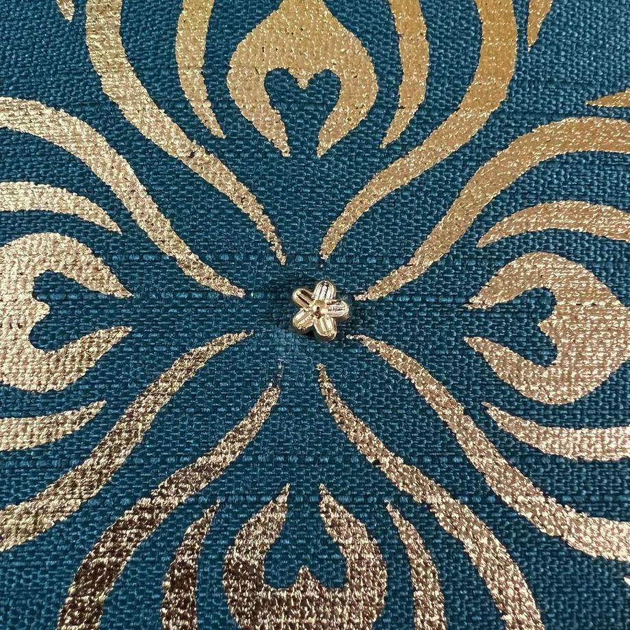 Close up of the gold print on the Teal Cushion Cover